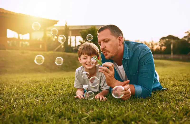 blowing bubbles on lawn