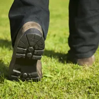 tech walking on grass