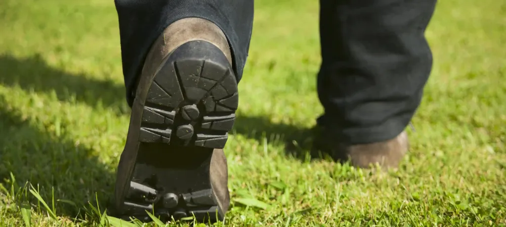 tech walking on grass